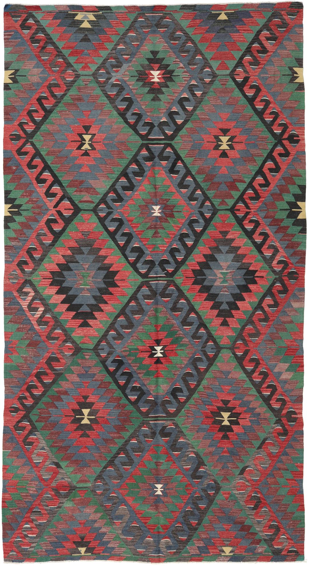 Tapis Kelim turc tissé à la main avec un motif géométrique vibrant en rouge, vert et noir.