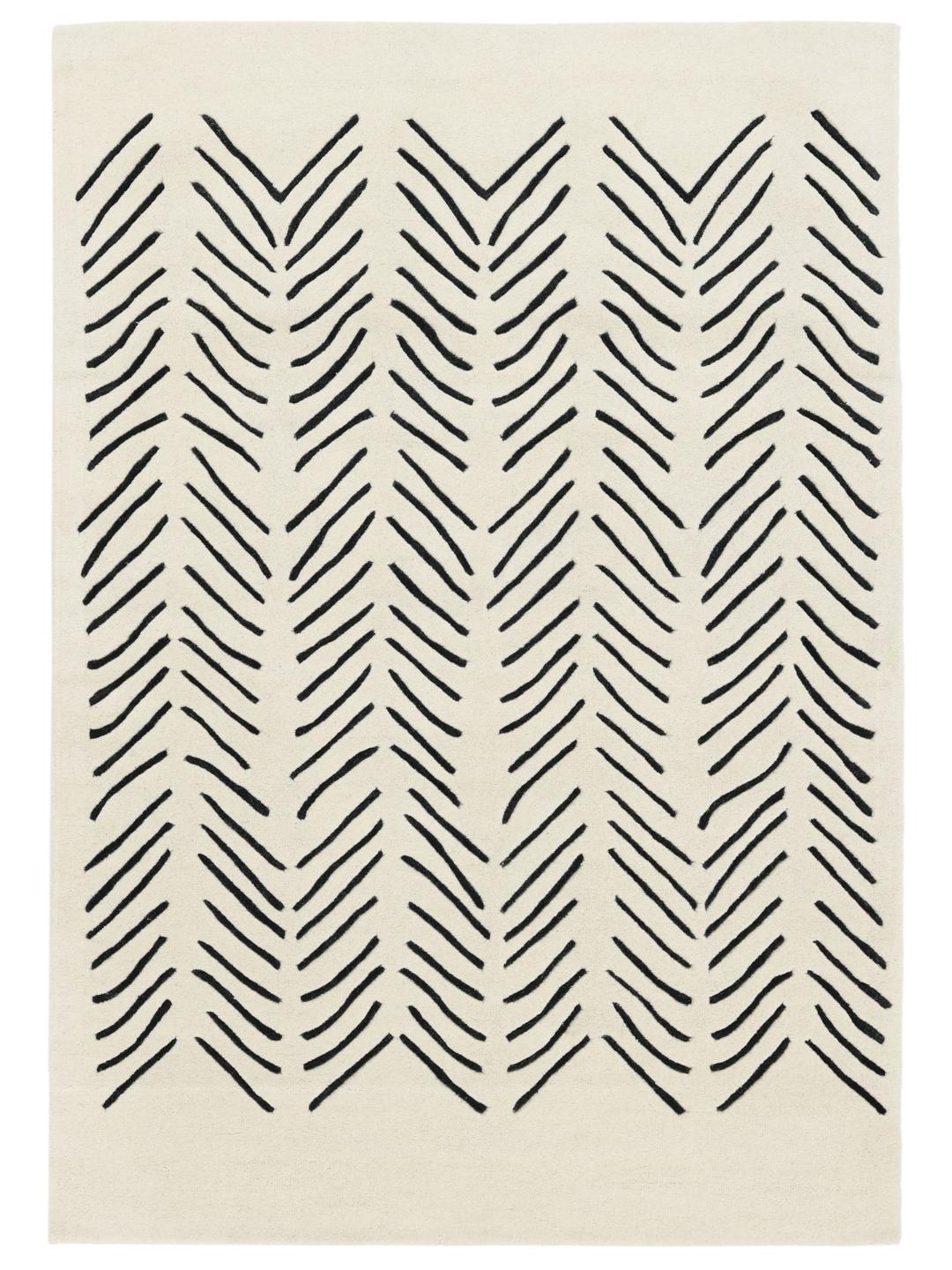A rectangular rug with a white background and a black hand-tufted chevron pattern.