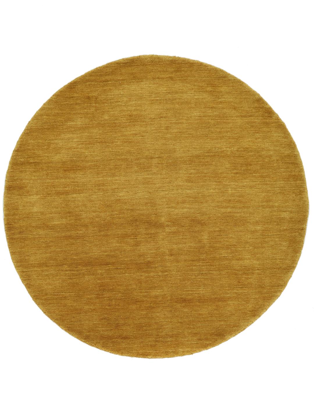 Tapis rond en laine jaune moutarde avec une texture à poils doux