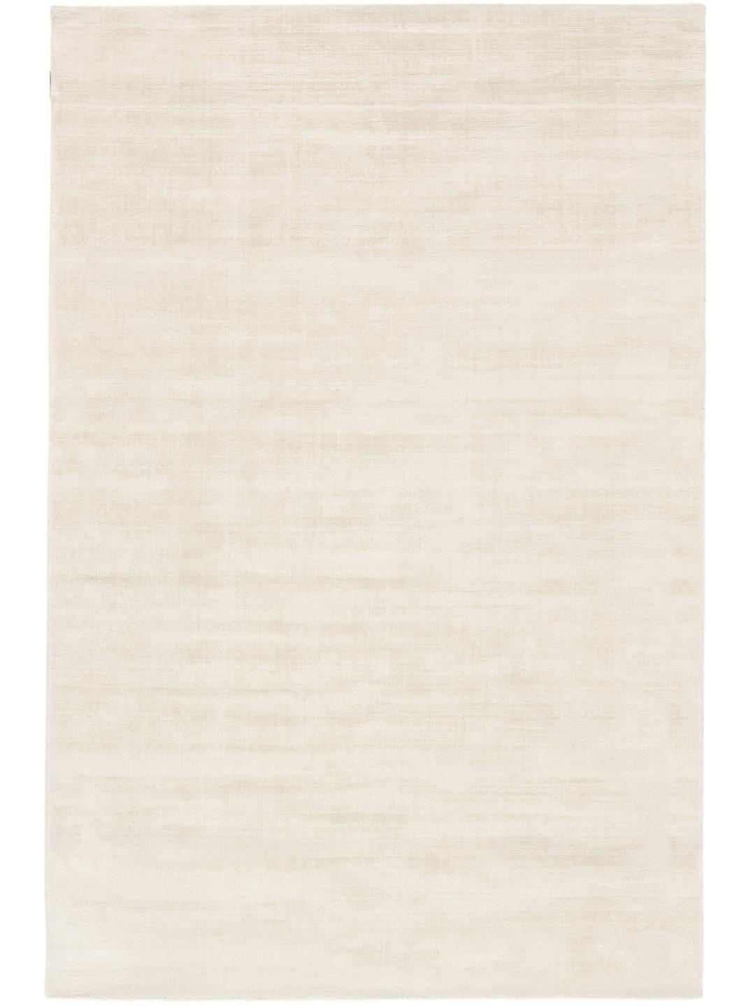 A soft ivory white rug with a subtle, tactile surface.