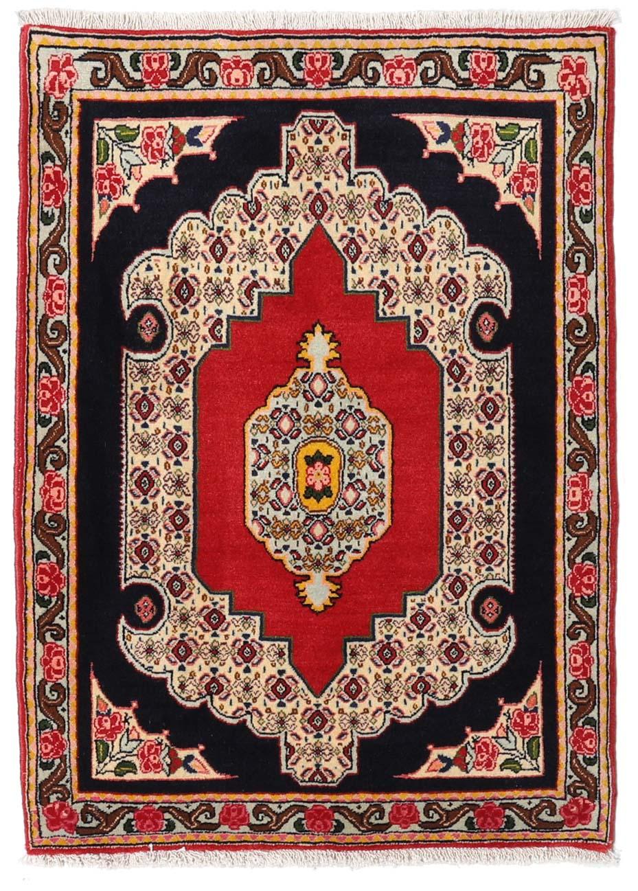 A hand-knotted Senneh rug from the Middle East featuring a vibrant red and black colour palette.