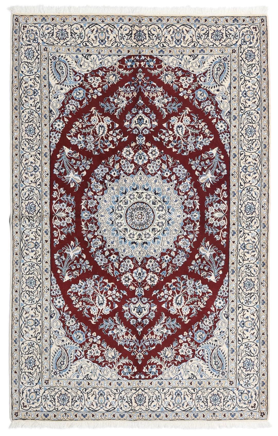 Nain rug from the Middle East featuring a central floral medallion in dark-red and blue
