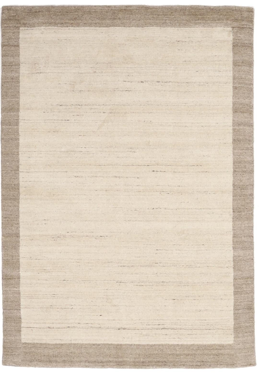 A rectangular rug in natural white and beige with a simple border design.