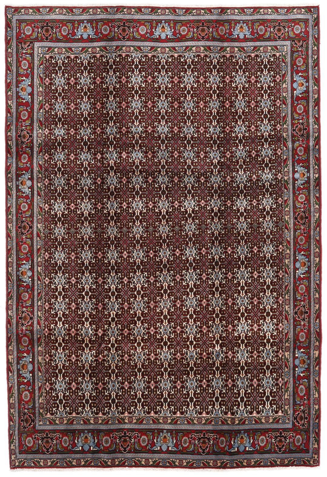 A hand-knotted Senneh rug from the Middle East featuring a dark-red field with geometric motifs.