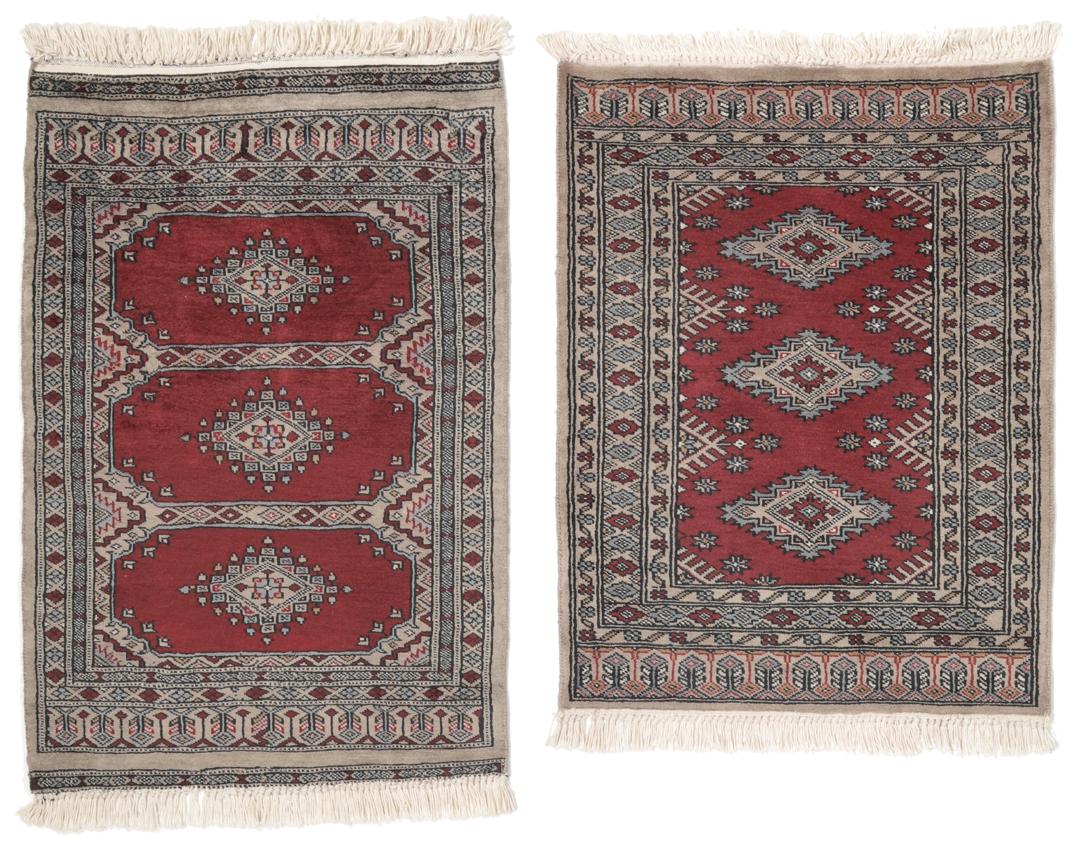 A red and beige hand-knotted Pakistan Bokhara rug with traditional geometric motifs.