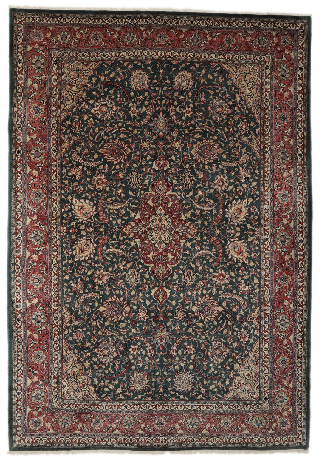 A hand-knotted Middle Eastern Sarough rug with a dark-blue field and floral patterns.