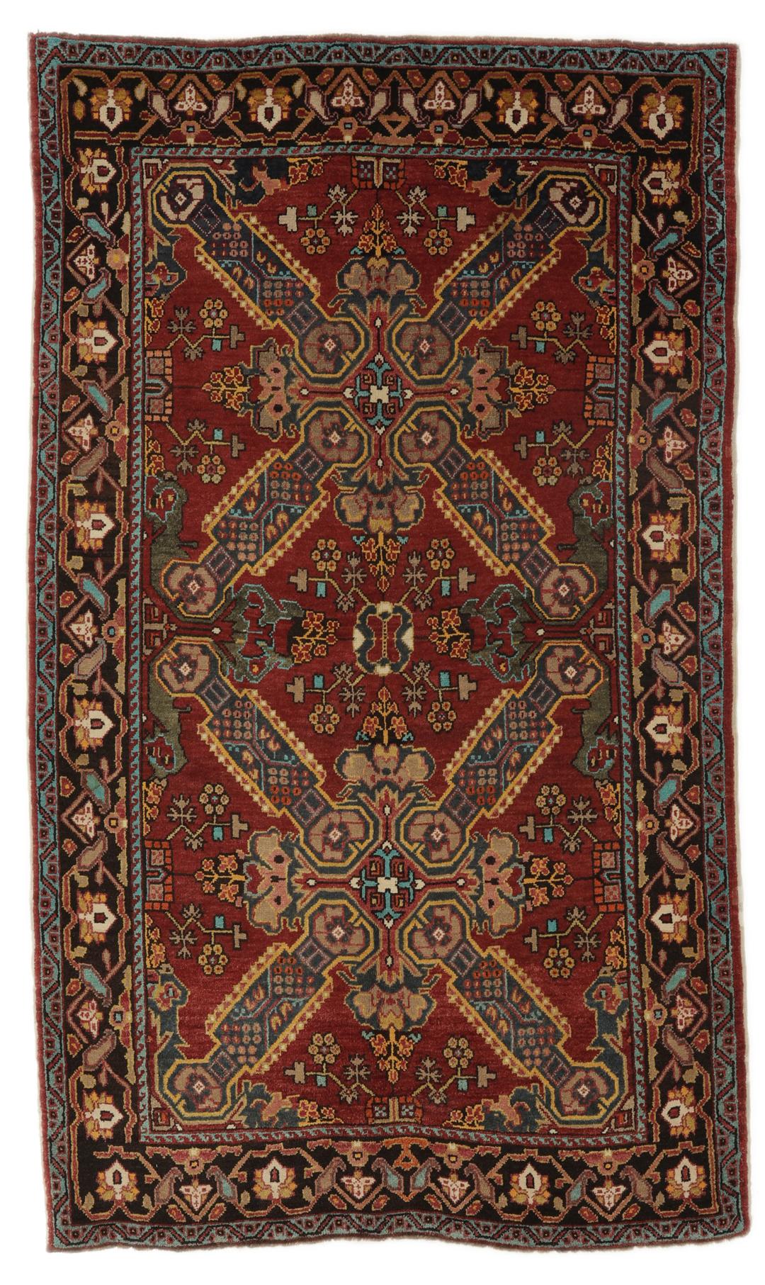 Antikt Shirvan-tæppe fra Mellemøsten med et levende rødt felt og komplekse geometriske motiver.