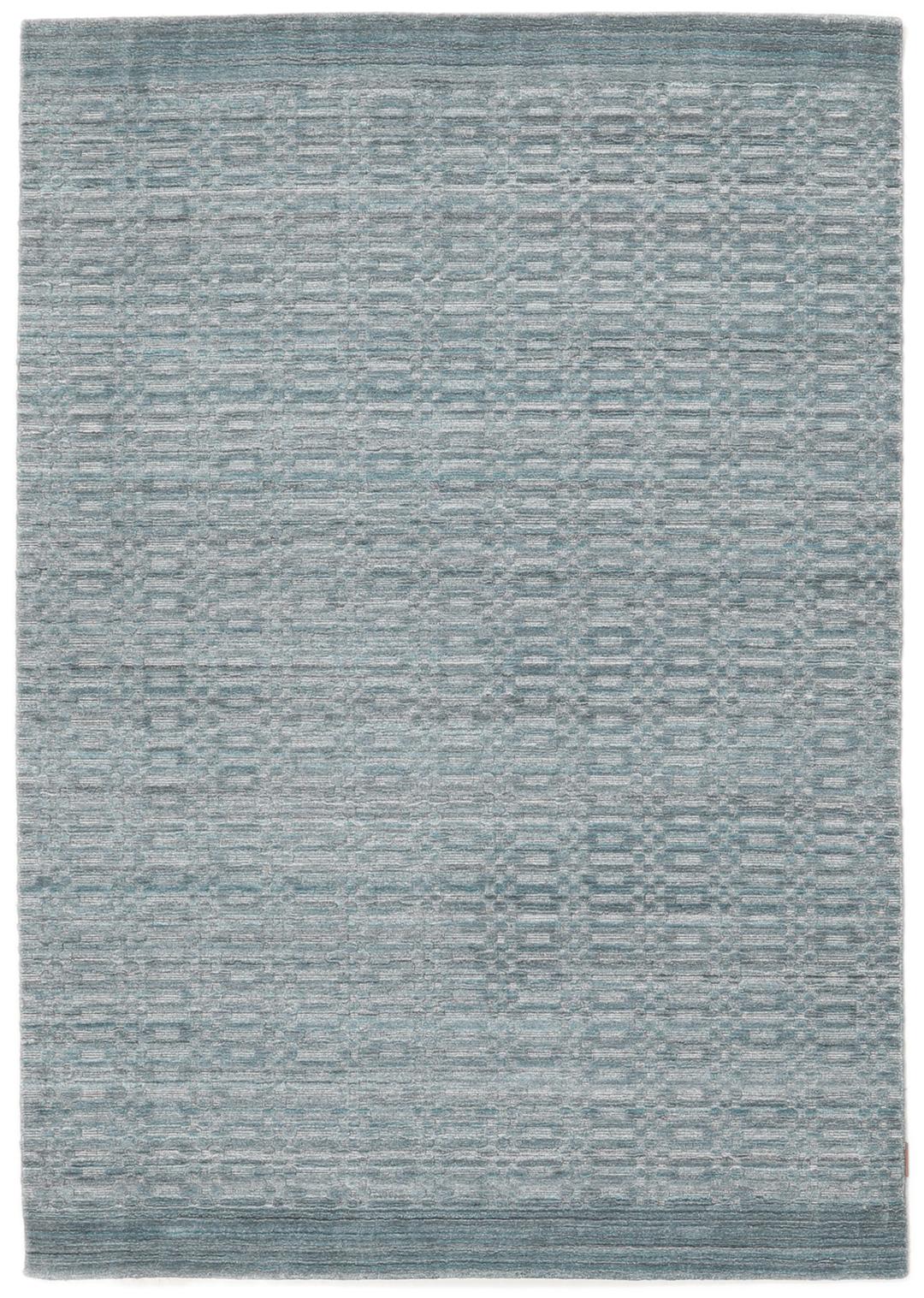 Un tapis rectangulaire bleu sarcelle avec un motif mosaïque texturé.