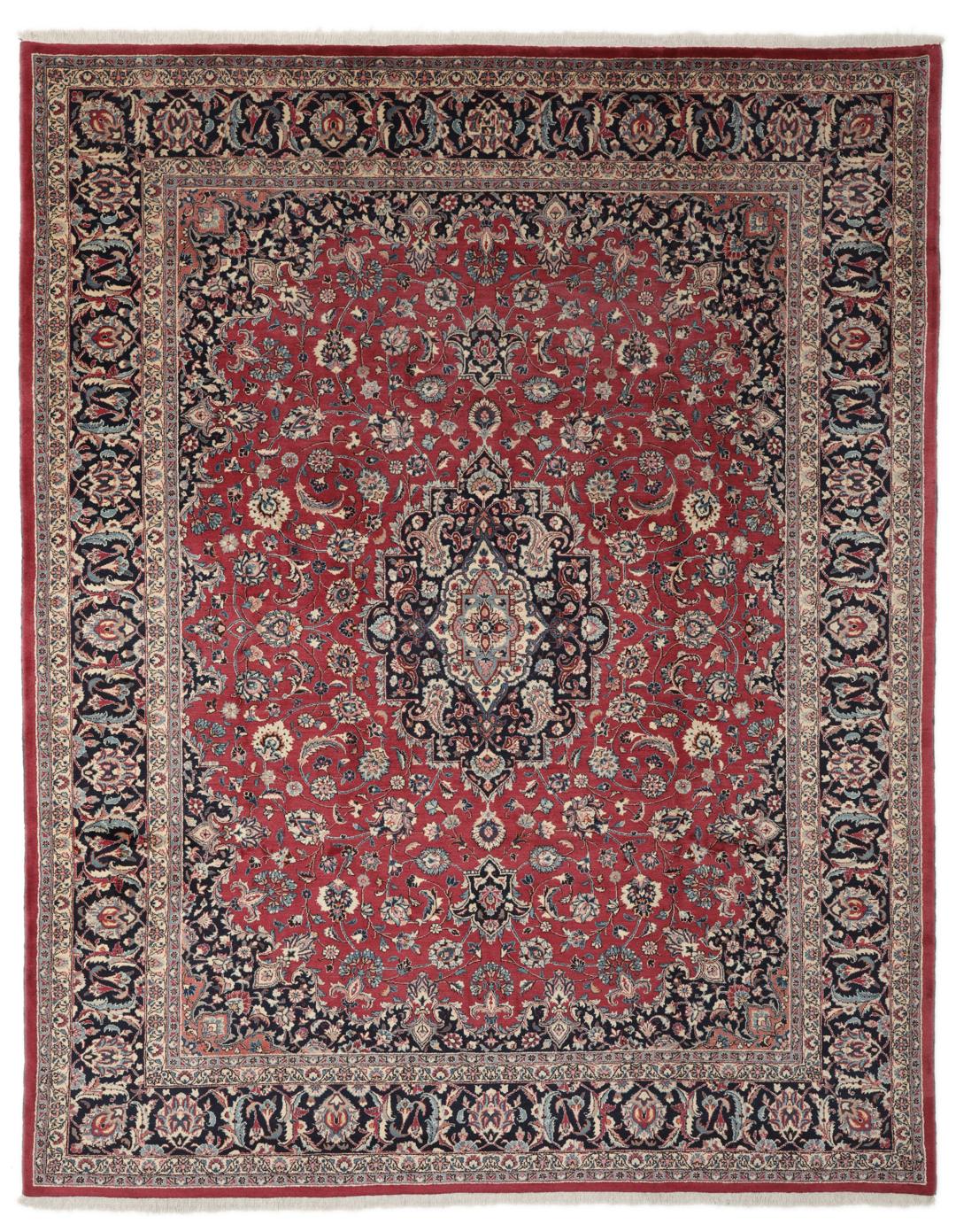 Hand-knotted Mashad rug from the Middle East in deep red and dark blue tones.