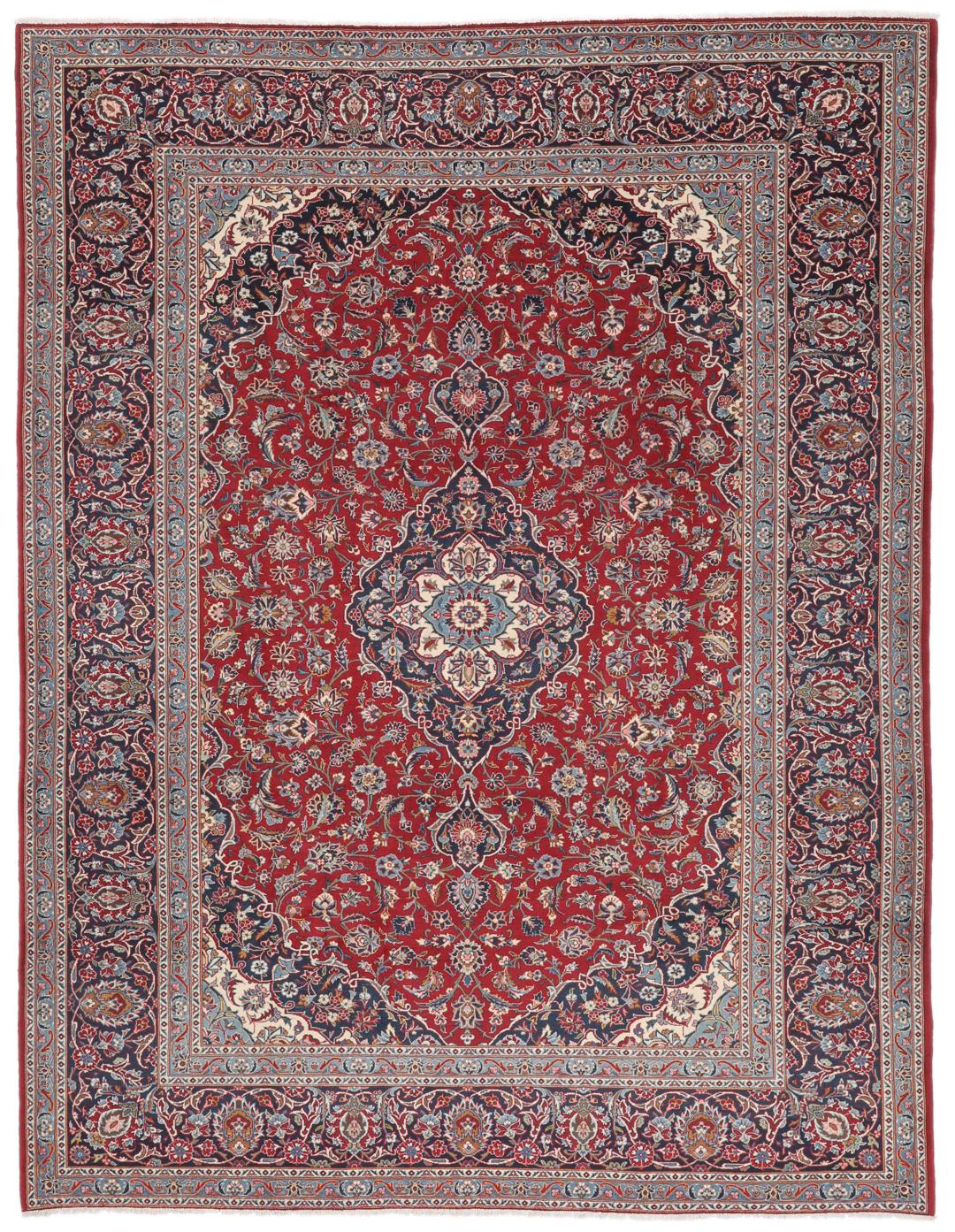 A hand-knotted Keshan rug from the Middle East with a red field and intricate floral patterns.