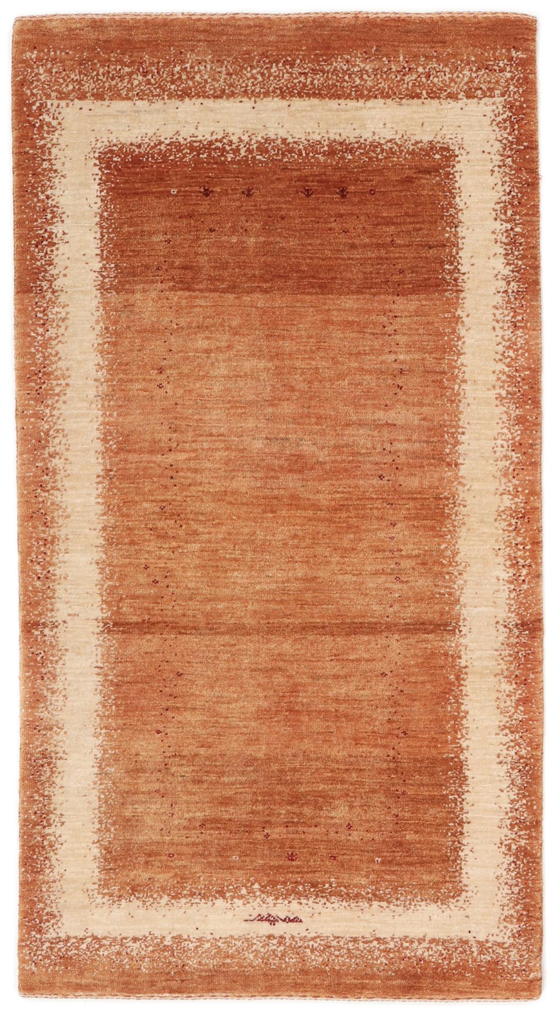 Hand-knotted Loribaft rug with a rich red and beige colour palette.