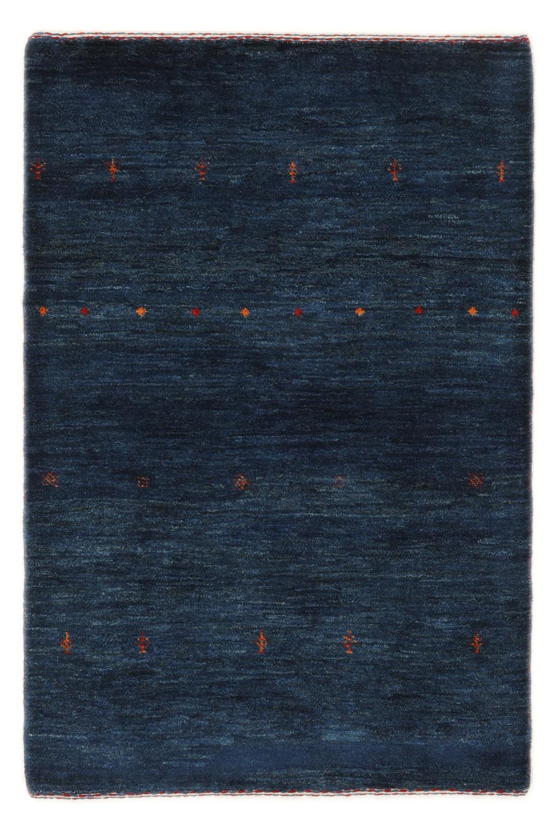A hand-knotted Loribaft rug from the Middle East in a deep blue colour with small orange accents.