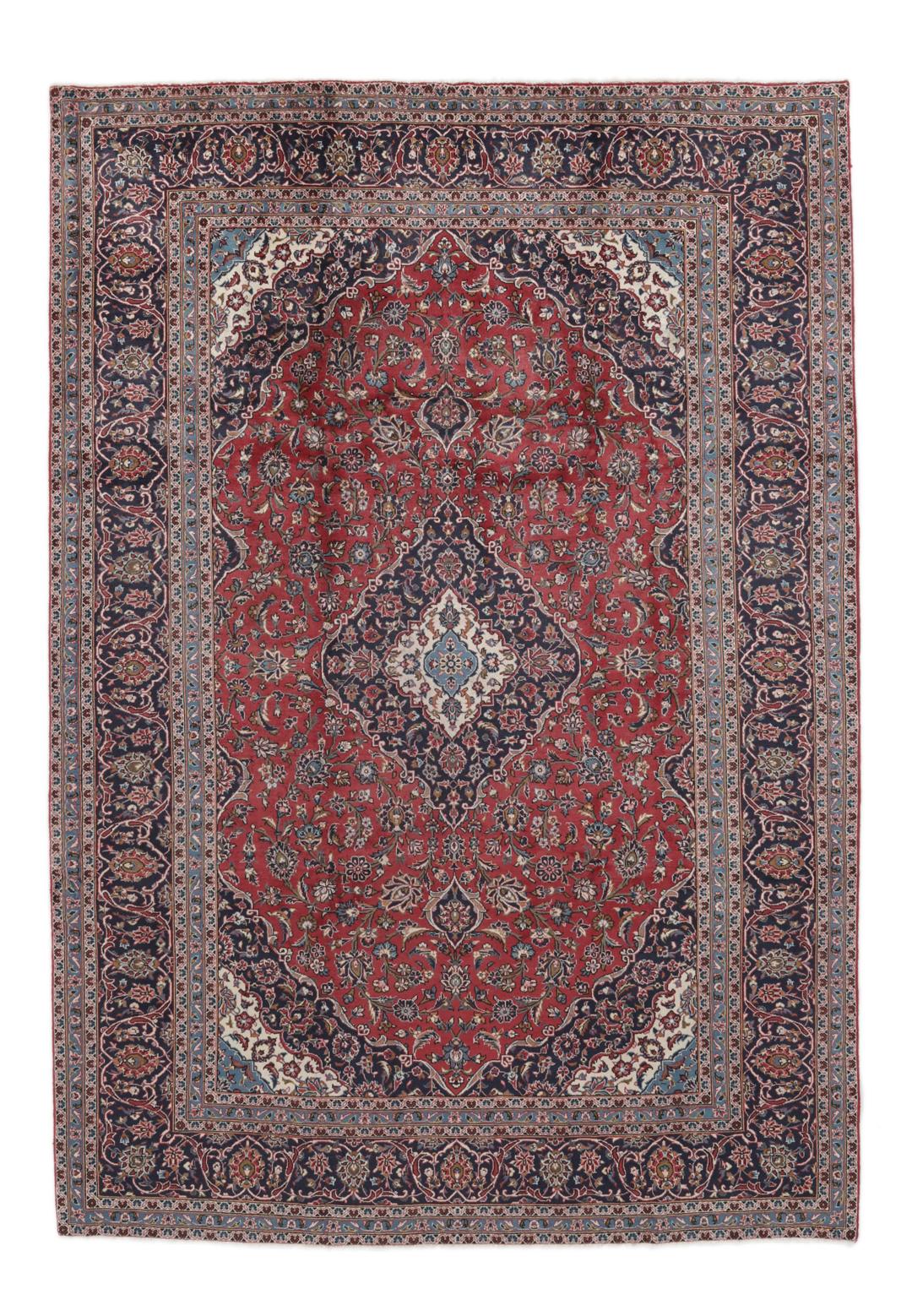 A hand-knotted Keshan rug from the Middle East with a red and dark-blue medallion pattern.