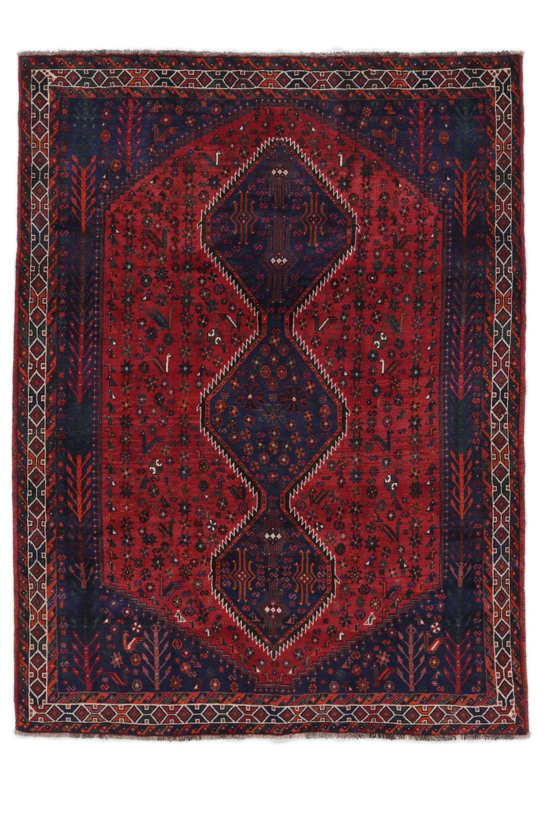 Hand-knotted Shiraz rug featuring deep blue and red tribal patterns