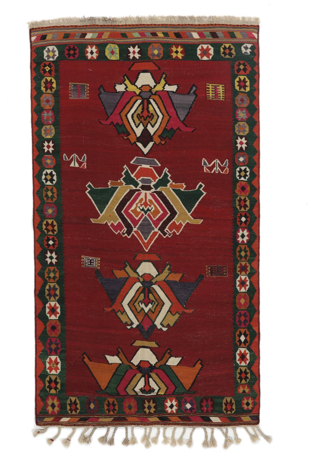 Un tapis kilim vintage tissé à la main provenant du Moyen-Orient, de couleur rouge profond avec des motifs géométriques