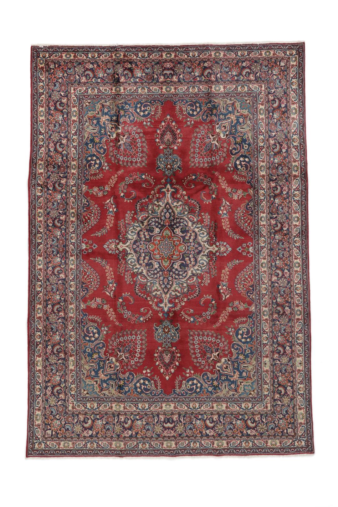 A hand-knotted red Mashad rug featuring a traditional floral medallion design