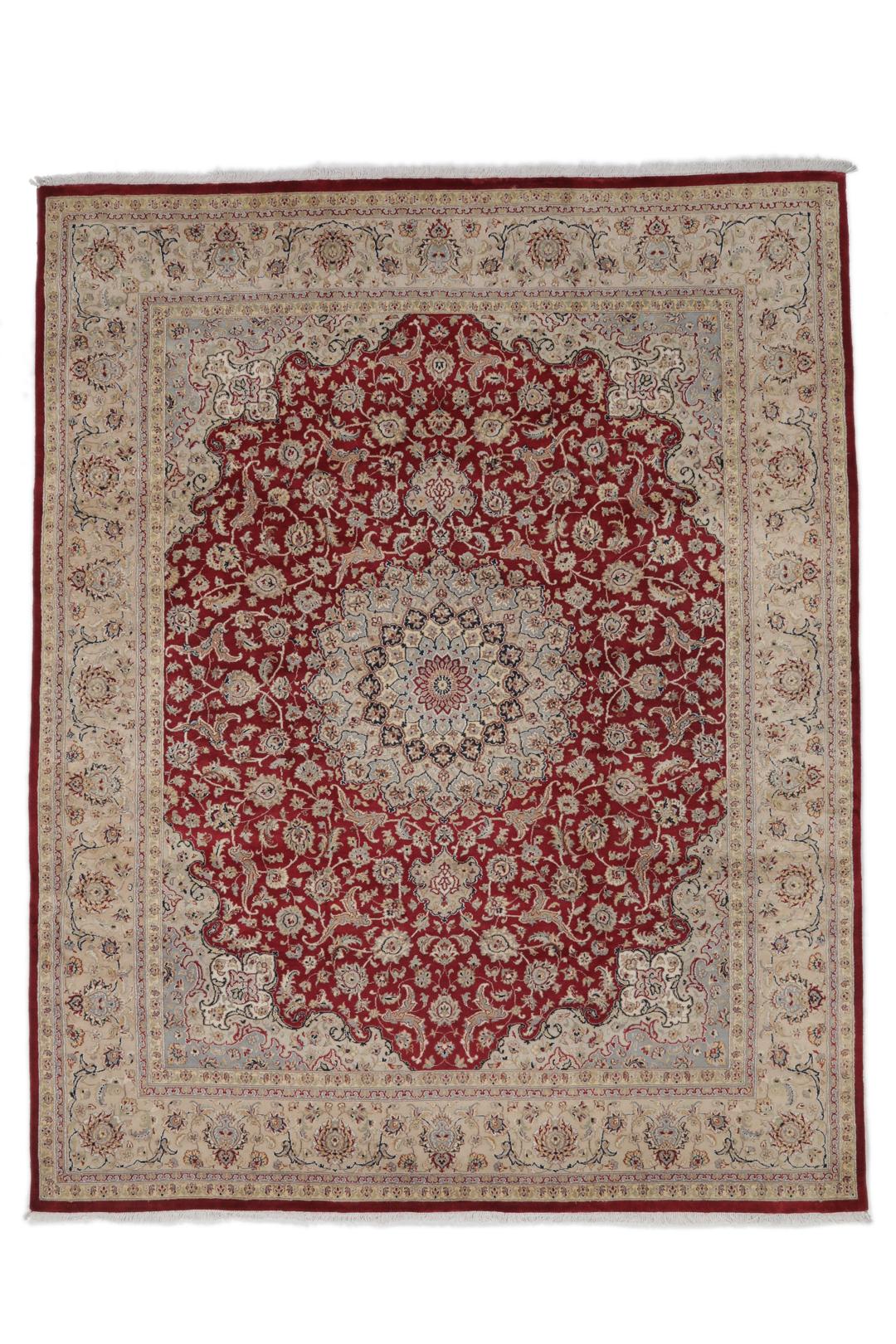 A large hand-knotted Tabriz rug from India with a red field and cream floral border.