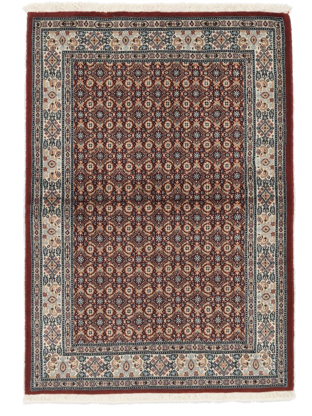 A hand-knotted Moud rug with traditional floral motifs in dark-red and blue tones.