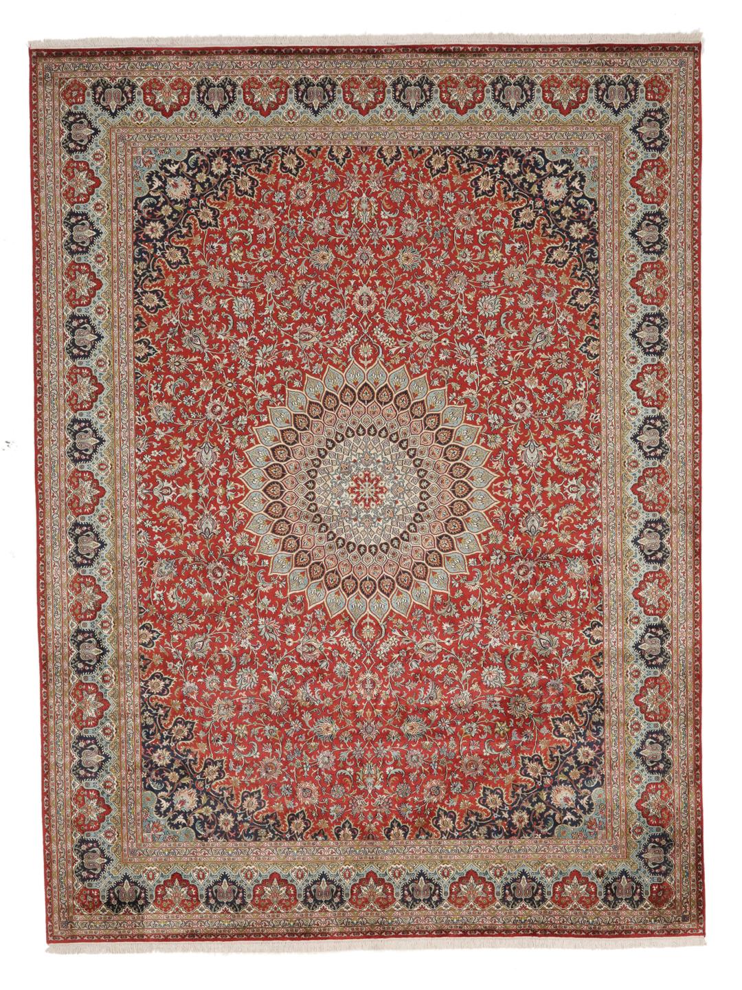 A large rectangular Kashmir silk rug from India with a central medallion on a red field.