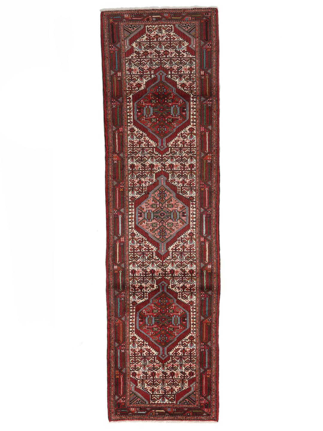 A hand-knotted Hamadan runner with traditional geometric patterns in red and cream.