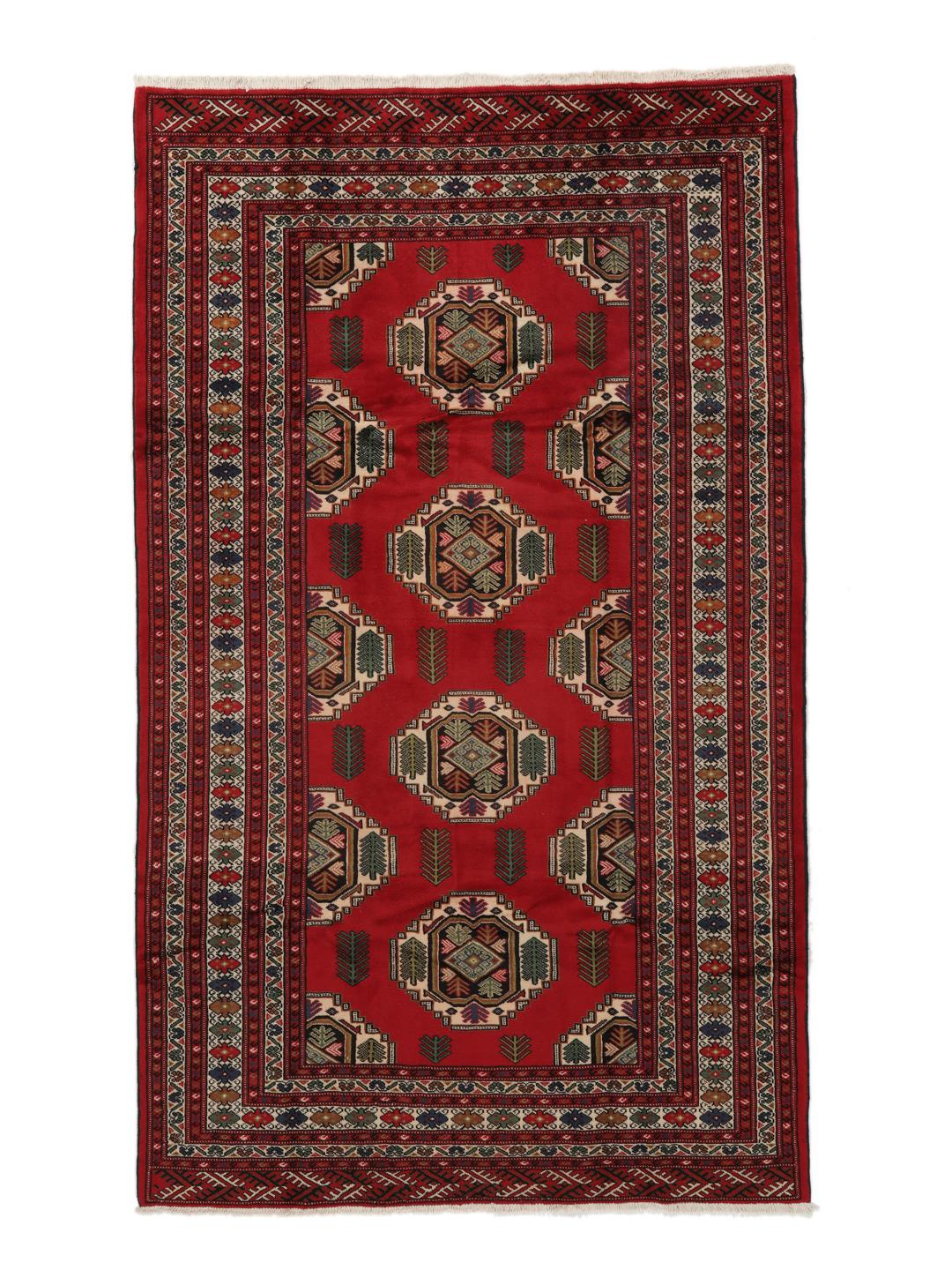 A hand-knotted Turkaman rug from the Middle East with a deep red field and traditional geometric motifs.