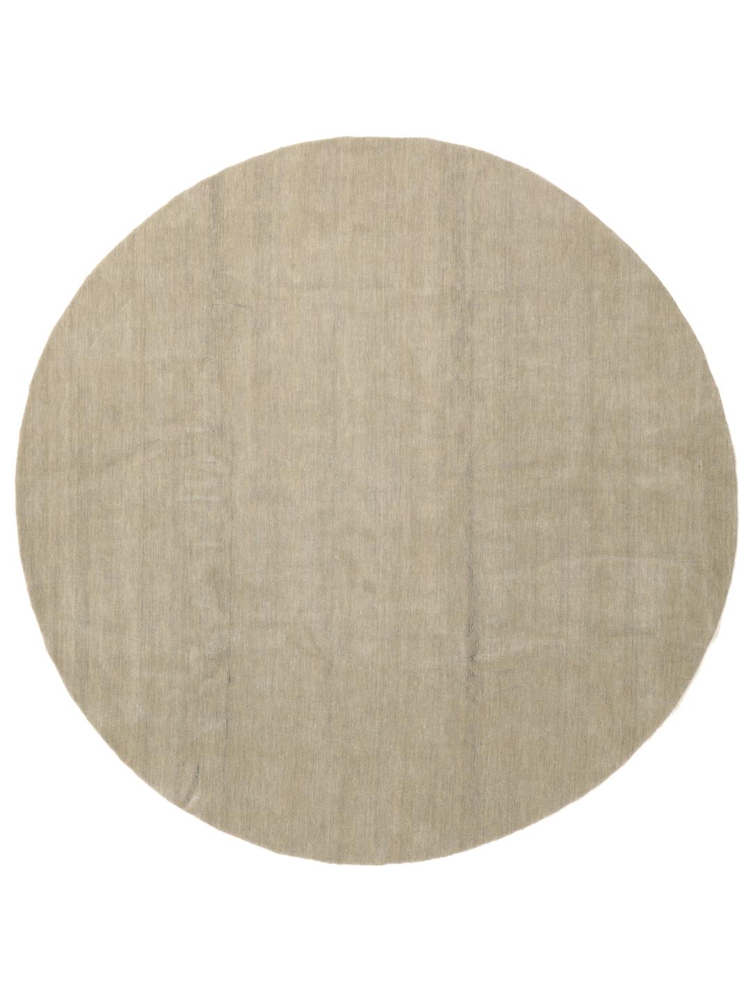 Rond beige handgeweven tapijt met een zachte textuur van wol