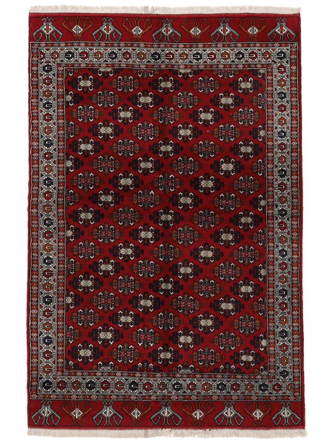 Hand-knotted Turkaman wool rug with a vibrant red field and tribal geometric patterns from the Middle East