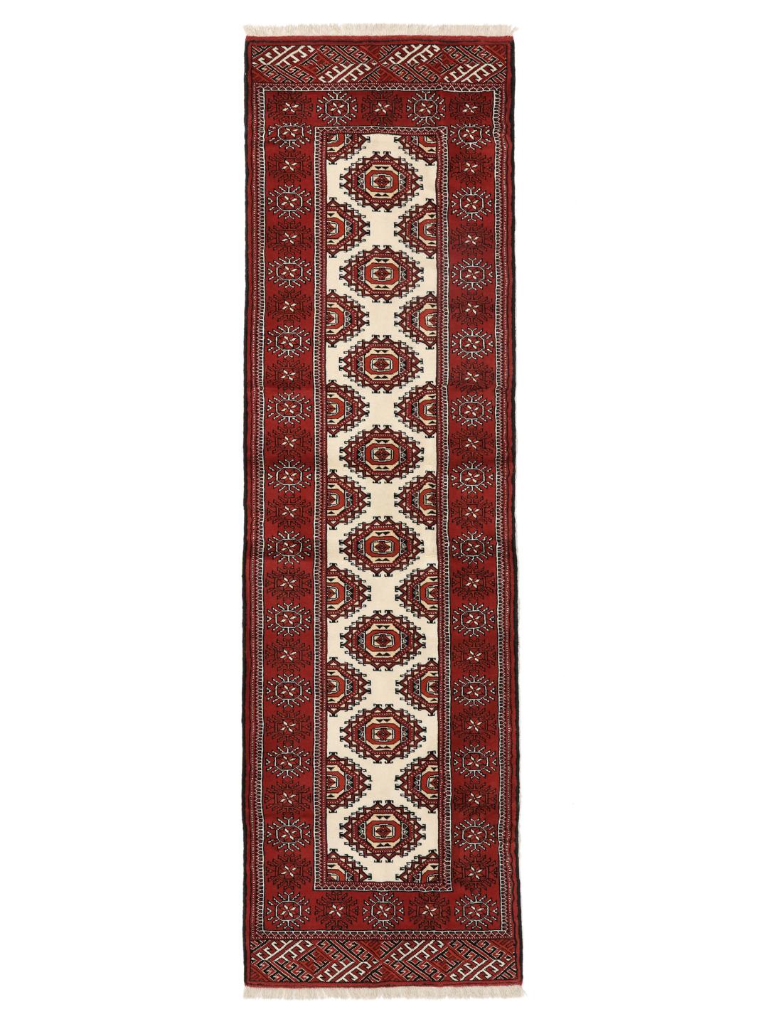 A hand-knotted red Turkaman runner with intricate geometric patterns.