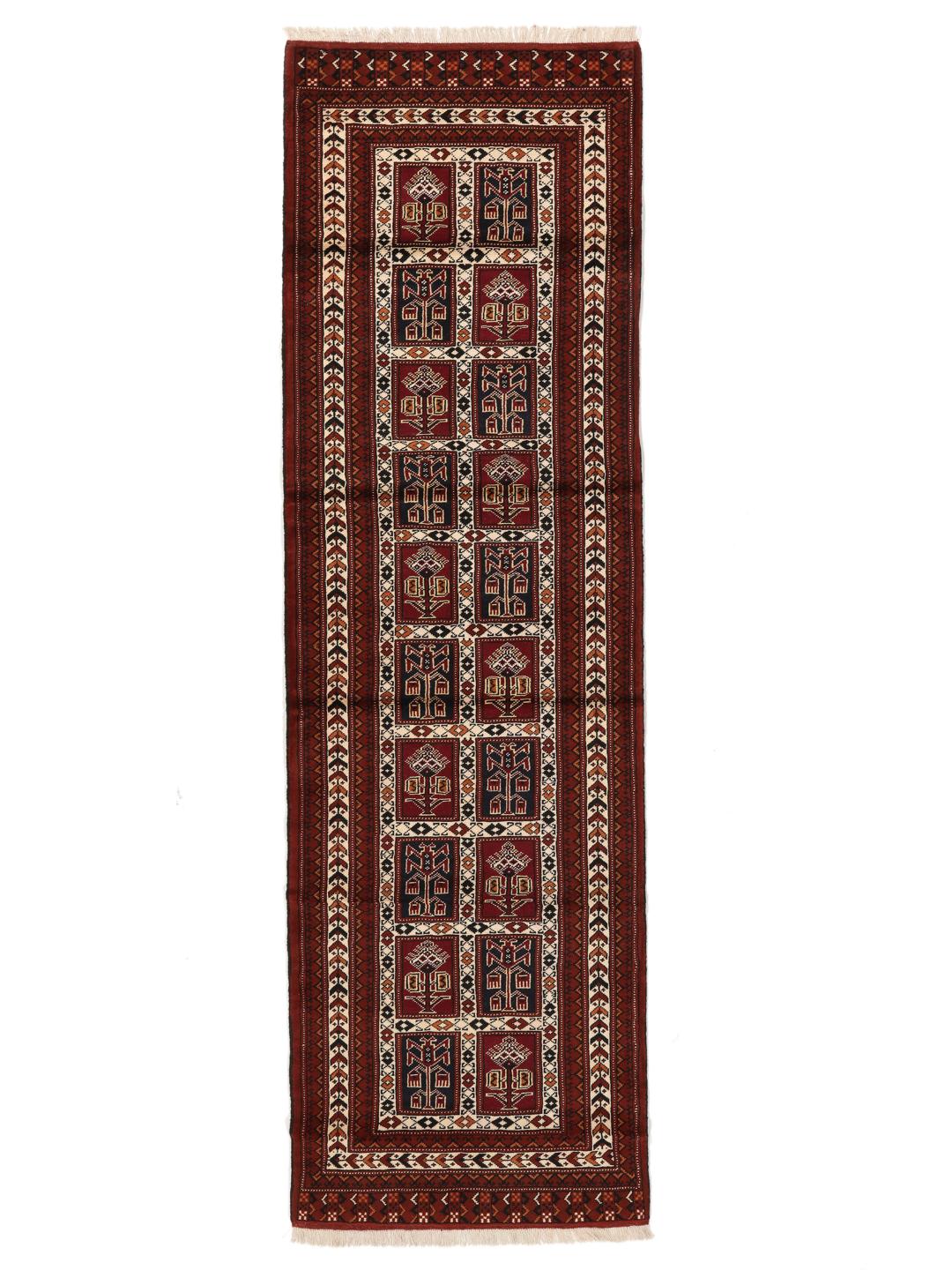 A hand-knotted Turkaman runner from the Middle East featuring a dark-red field with geometric motifs.