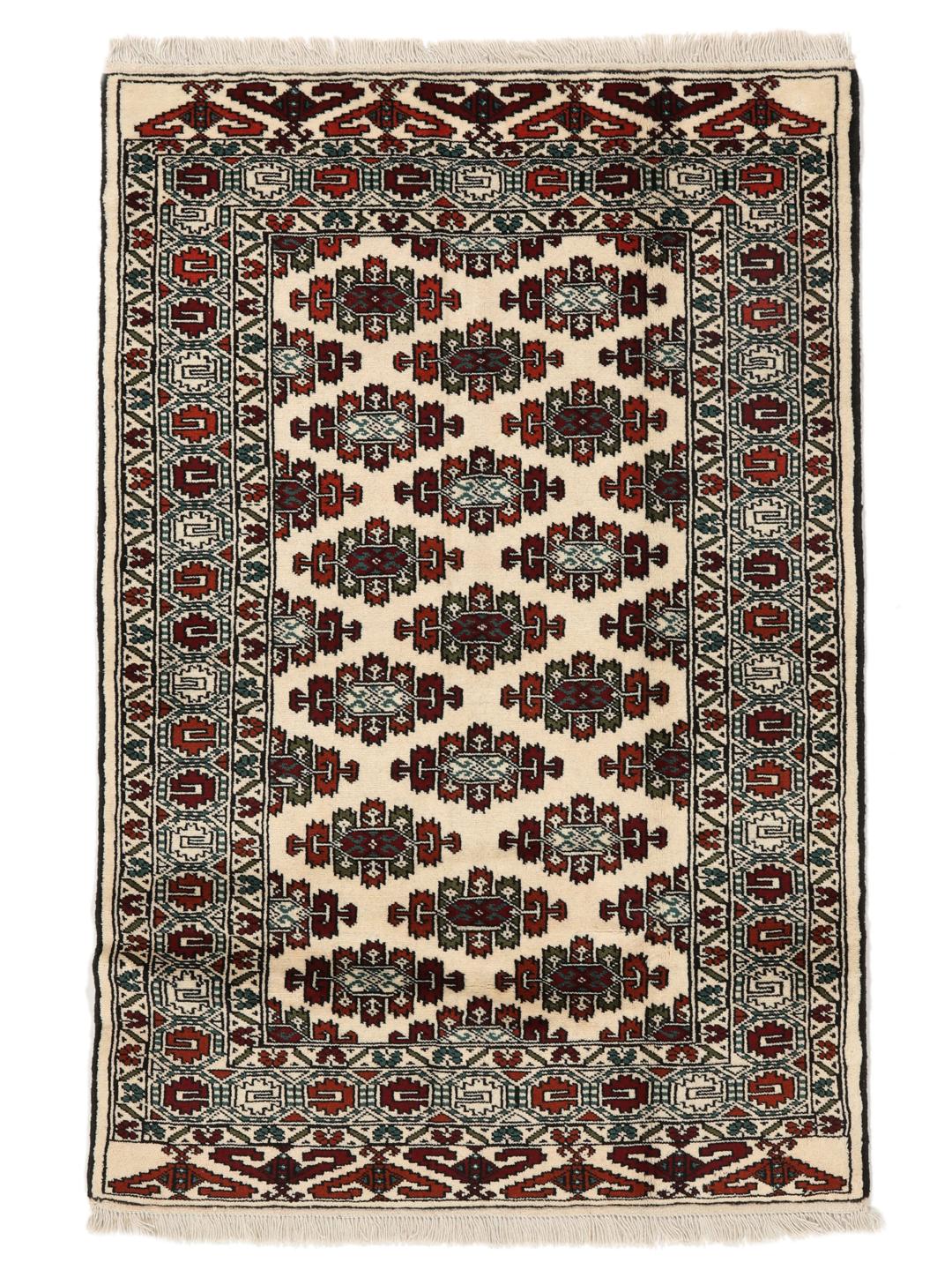 Hand-knotted Turkaman rug from the Middle East with a beige background and traditional geometric motifs.