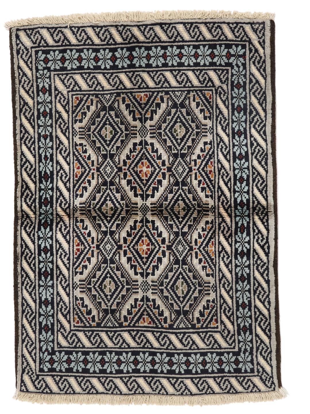 Hand-knotted Beluch rug from the Middle East in dark-blue and cream tones.