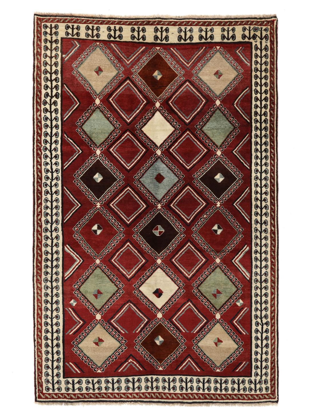 Hand-knotted Ghashghai rug from the Middle East featuring a vibrant red field with geometric diamond motifs.