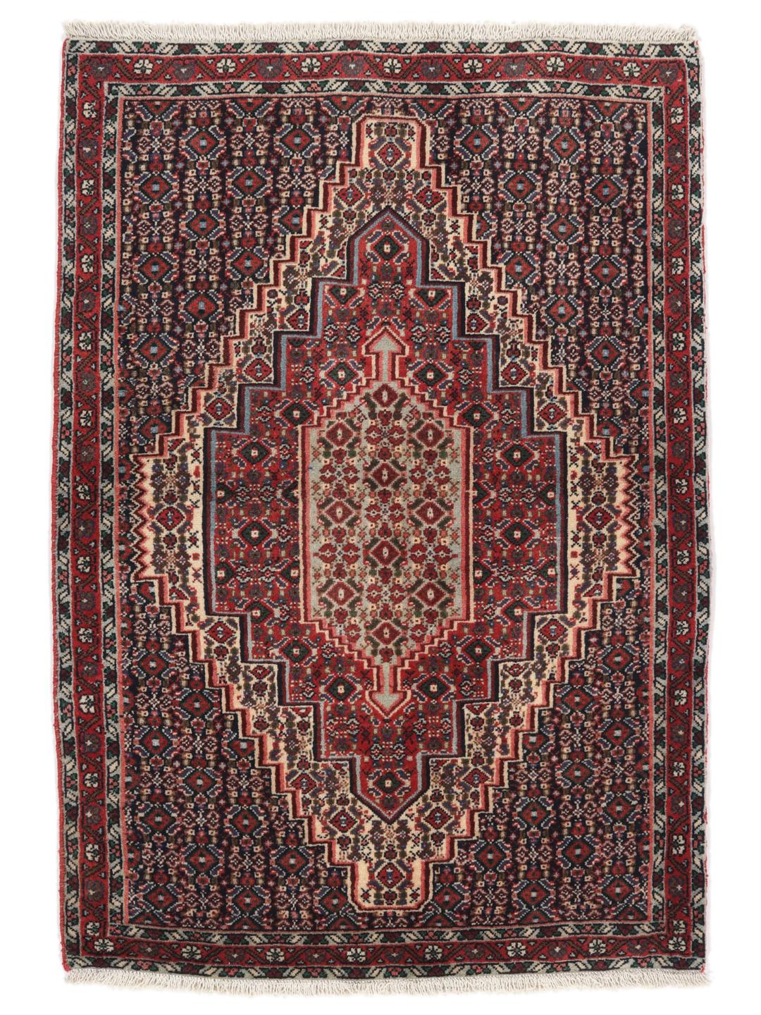 Hand-knotted Senneh wool rug in red with intricate geometric medallion patterns