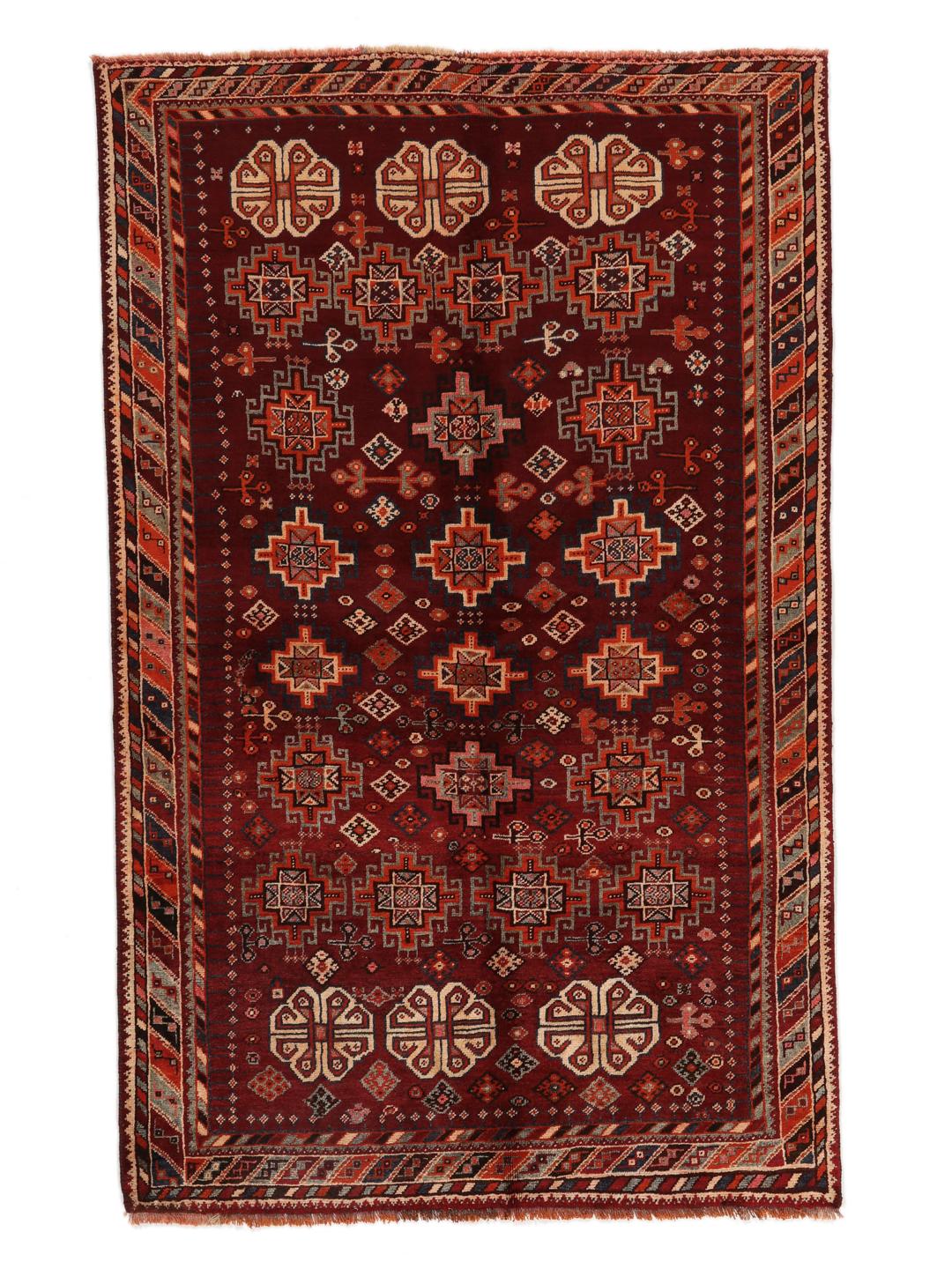 Hand-knotted Qashqai rug from the Middle East featuring geometric patterns in dark red and multicolour wool.