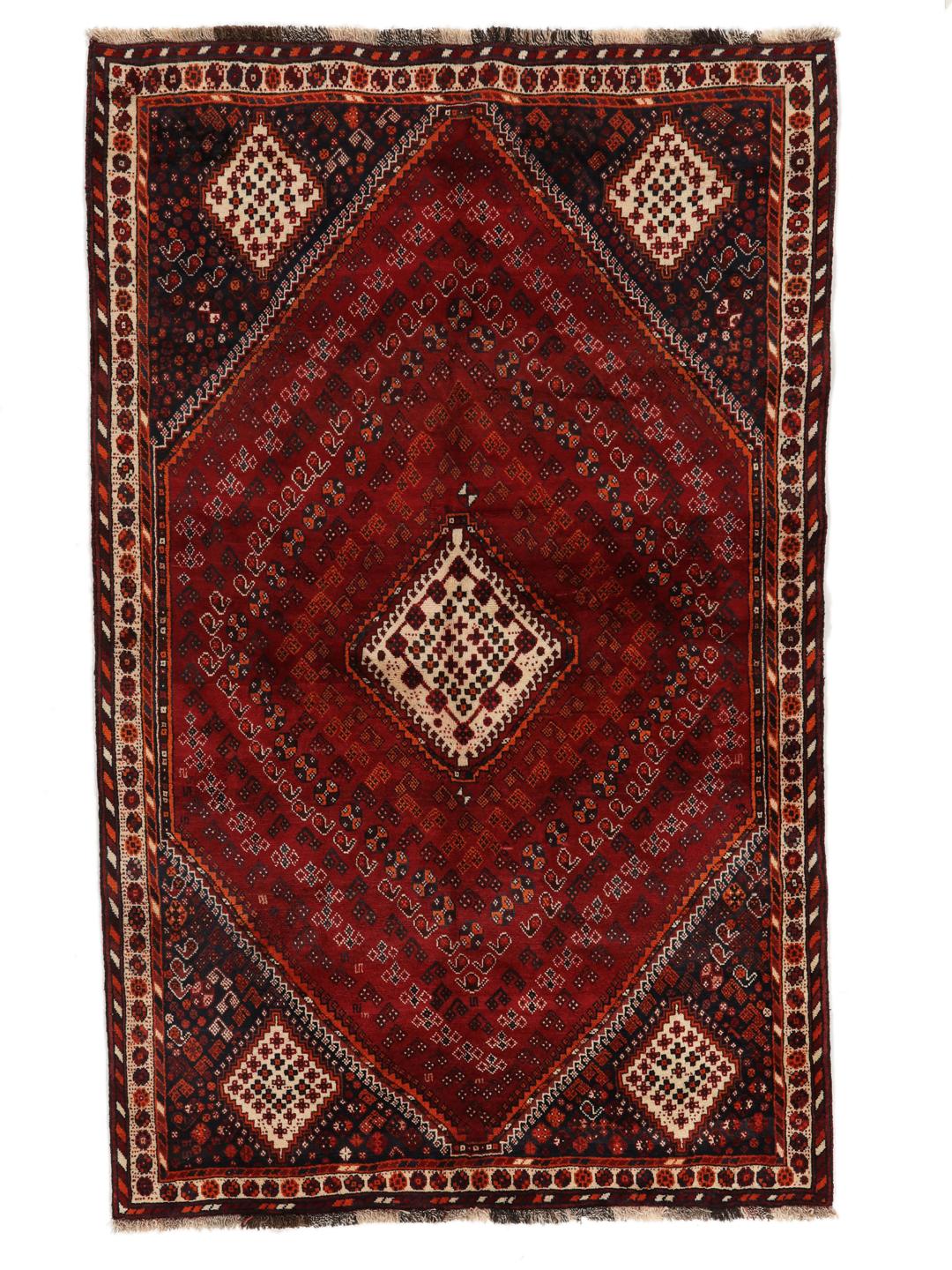 Hand-knotted Qashqai rug from the Middle East with a red field and geometric patterns