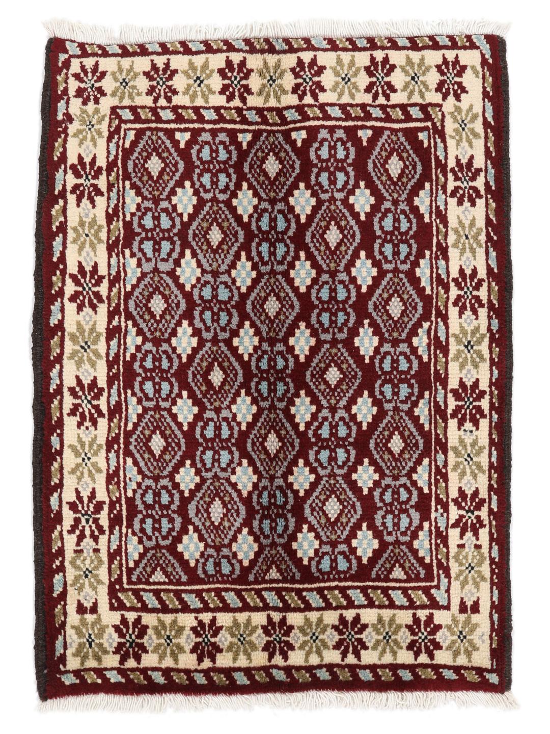 Hand-knotted Beluch rug with geometric motifs in red, blue, and cream