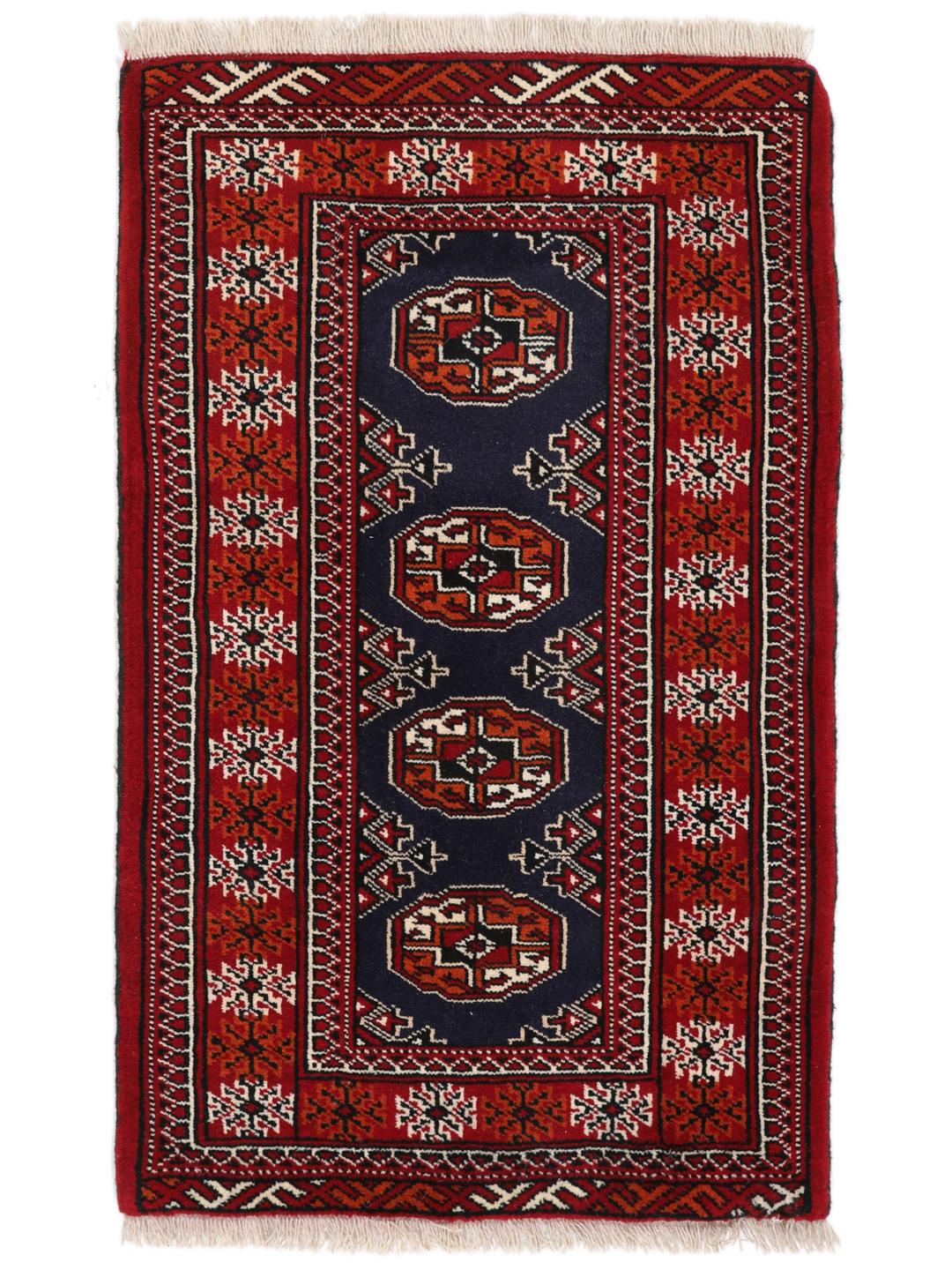 Hand-knotted Turkaman rug from the Middle East in dark-red and dark-blue tones.