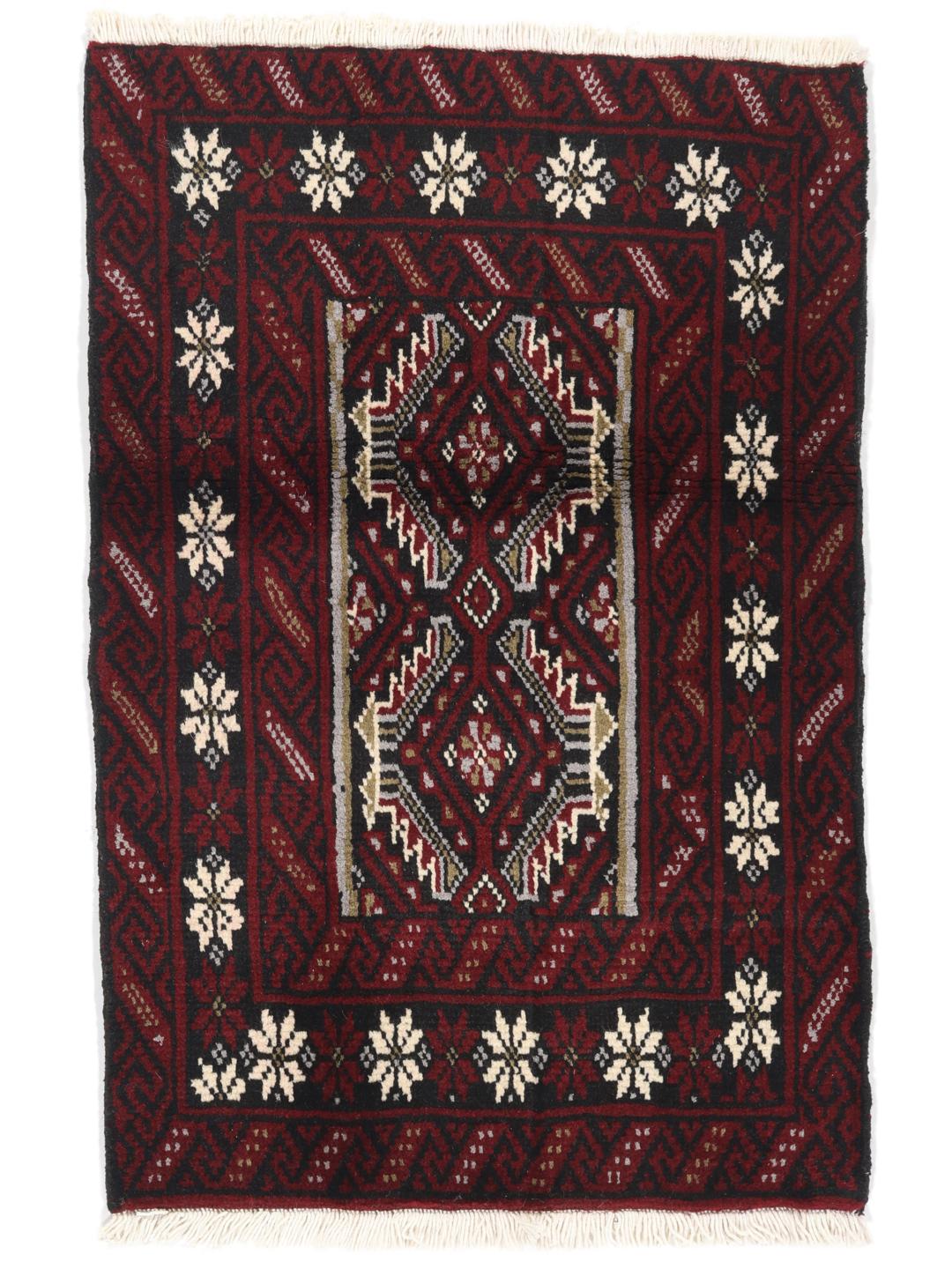 Hand-knotted Middle Eastern Beluch rug in dark red with floral and geometric patterns.