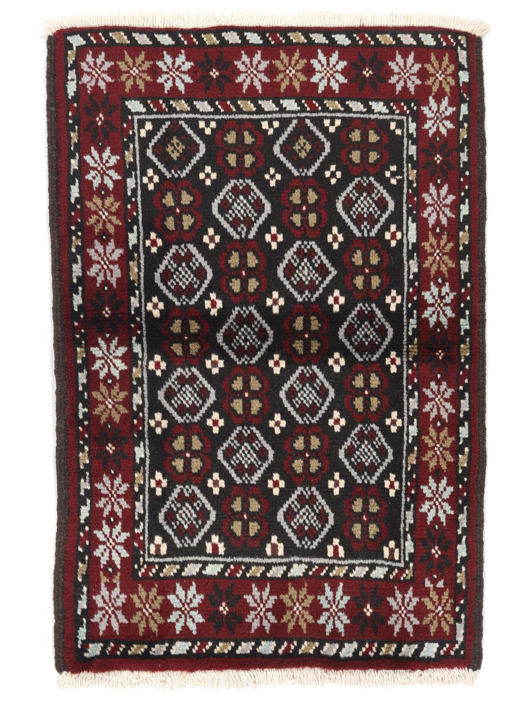 Hand-knotted Baluch rug in dark-red and black with traditional tribal geometric patterns