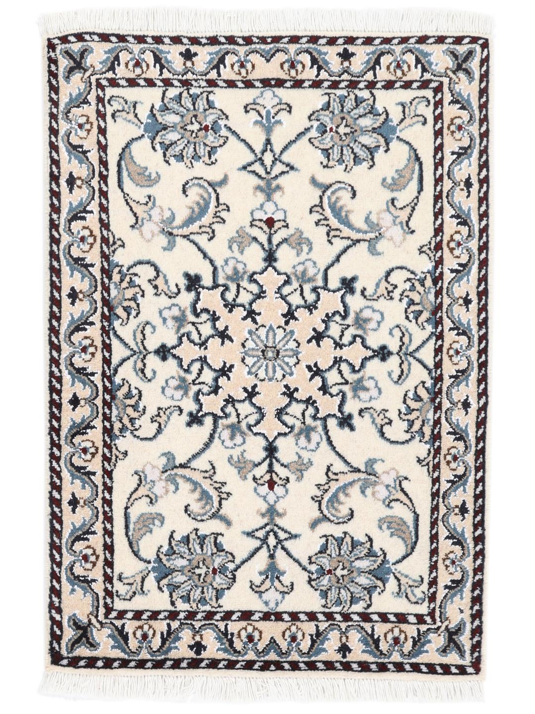 A hand-knotted floral Nain rug from the Middle East in beige and blue tones.