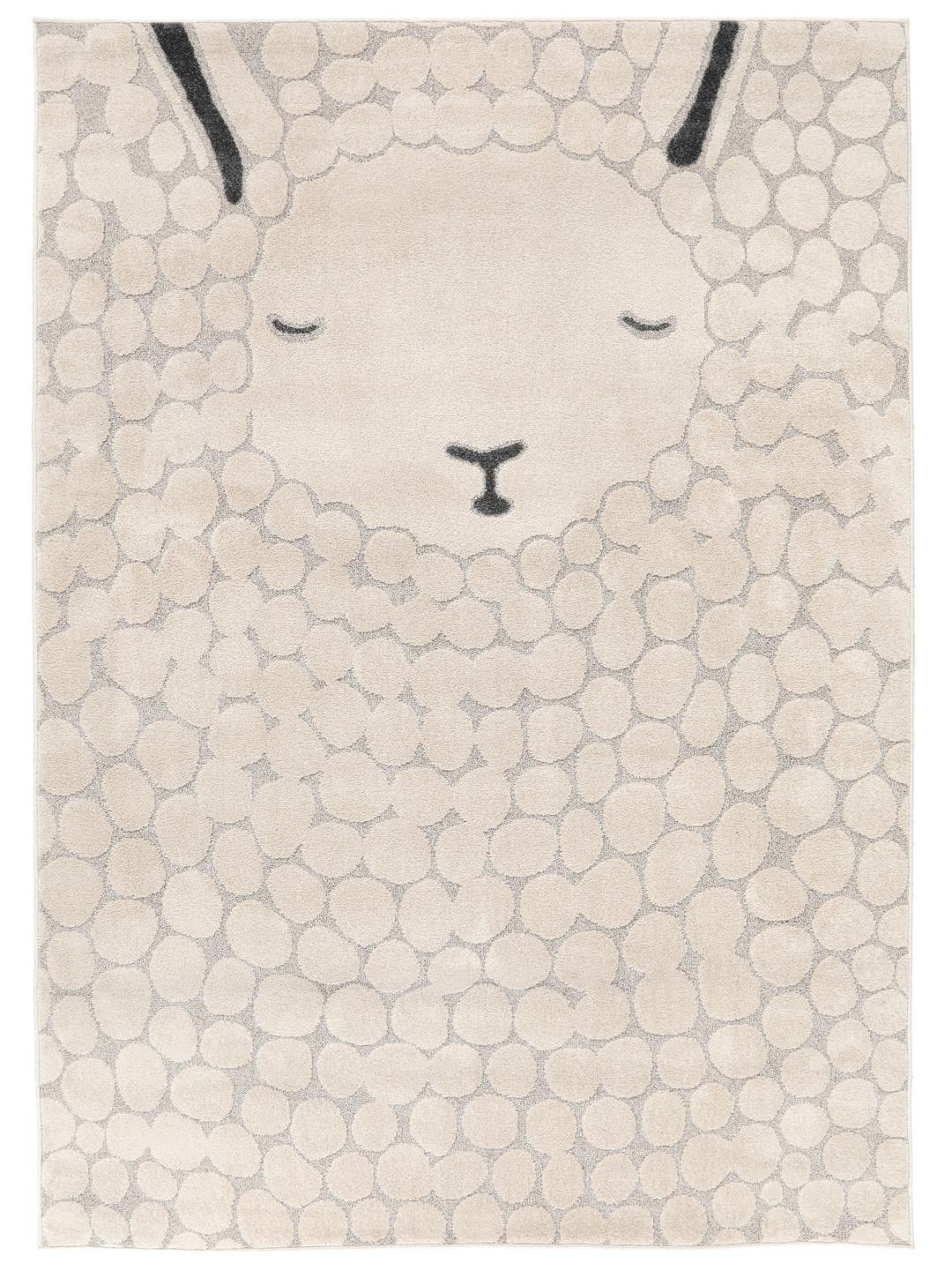 Un tapis pour enfant beige et gris présentant un motif de mouton stylisé avec une texture à poils longs et courts.