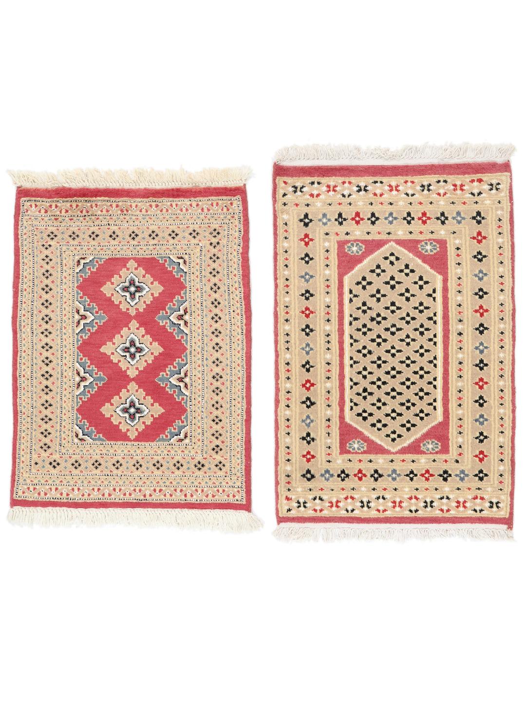 A set of two rectangular hand-knotted red Pakistan Bokhara rugs with intricate geometric patterns