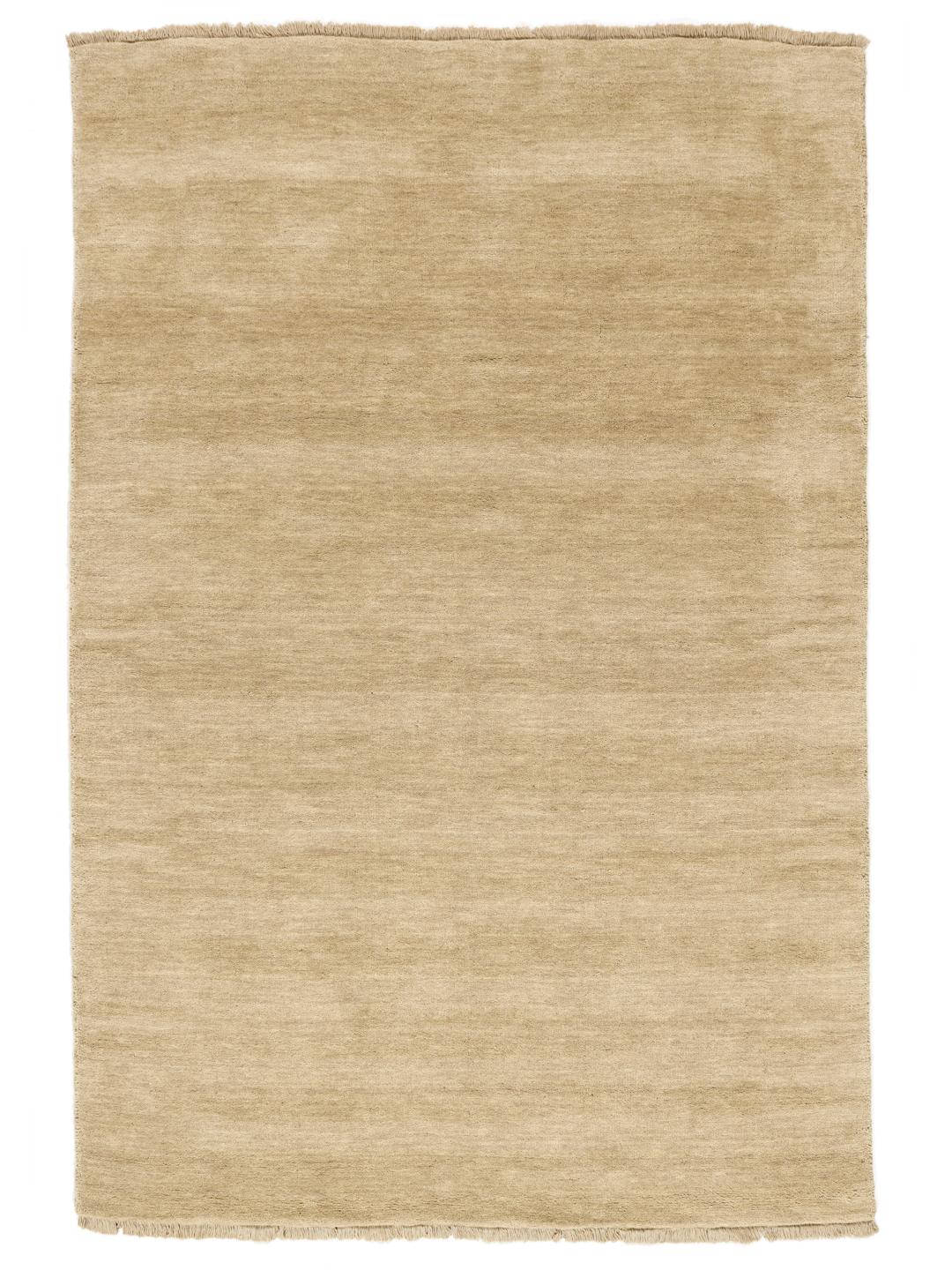 Een eenkleurig beige vloerkleed met verfijnde franjes