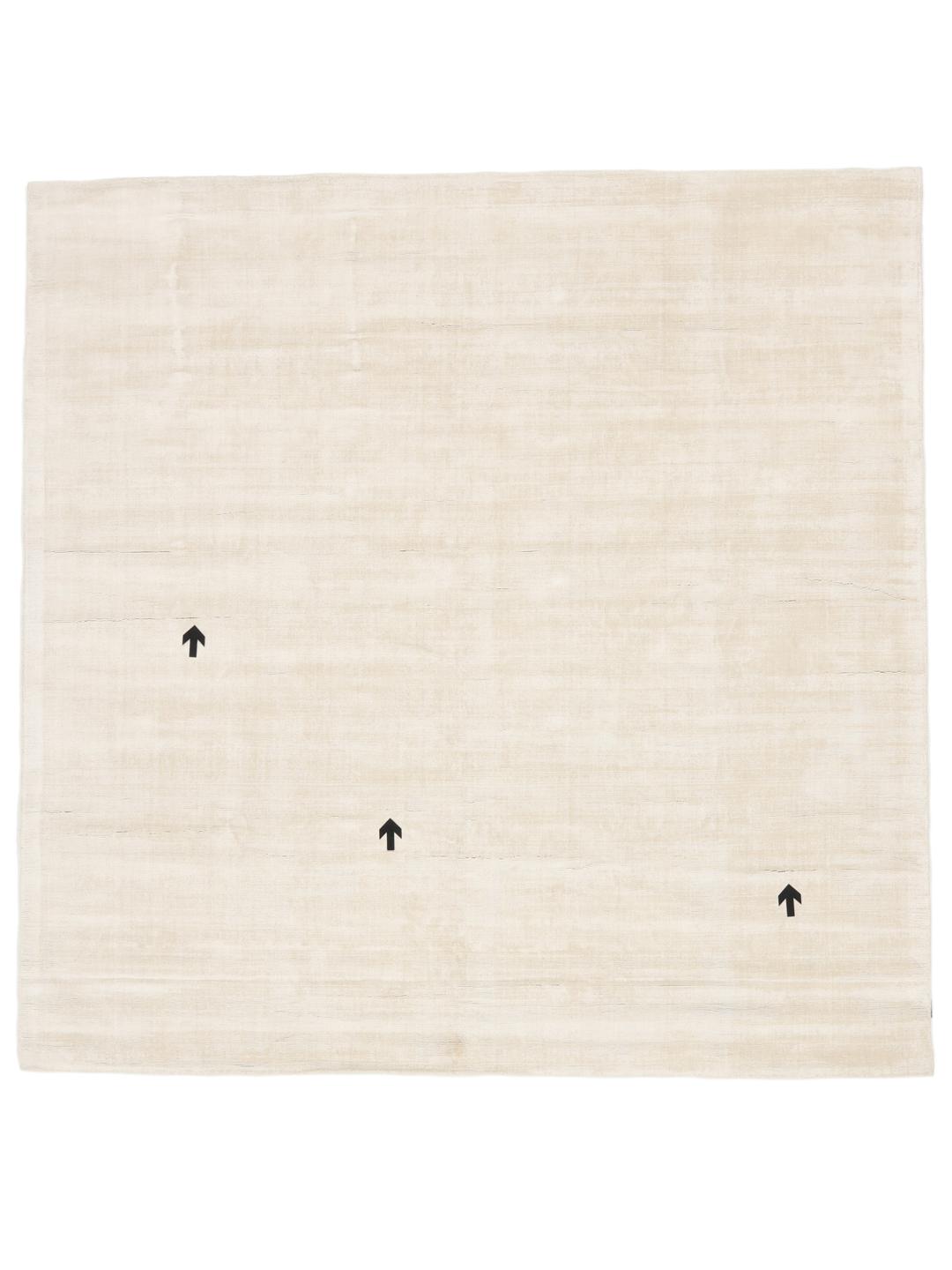Square beige rug with minimalist dark arrow accents