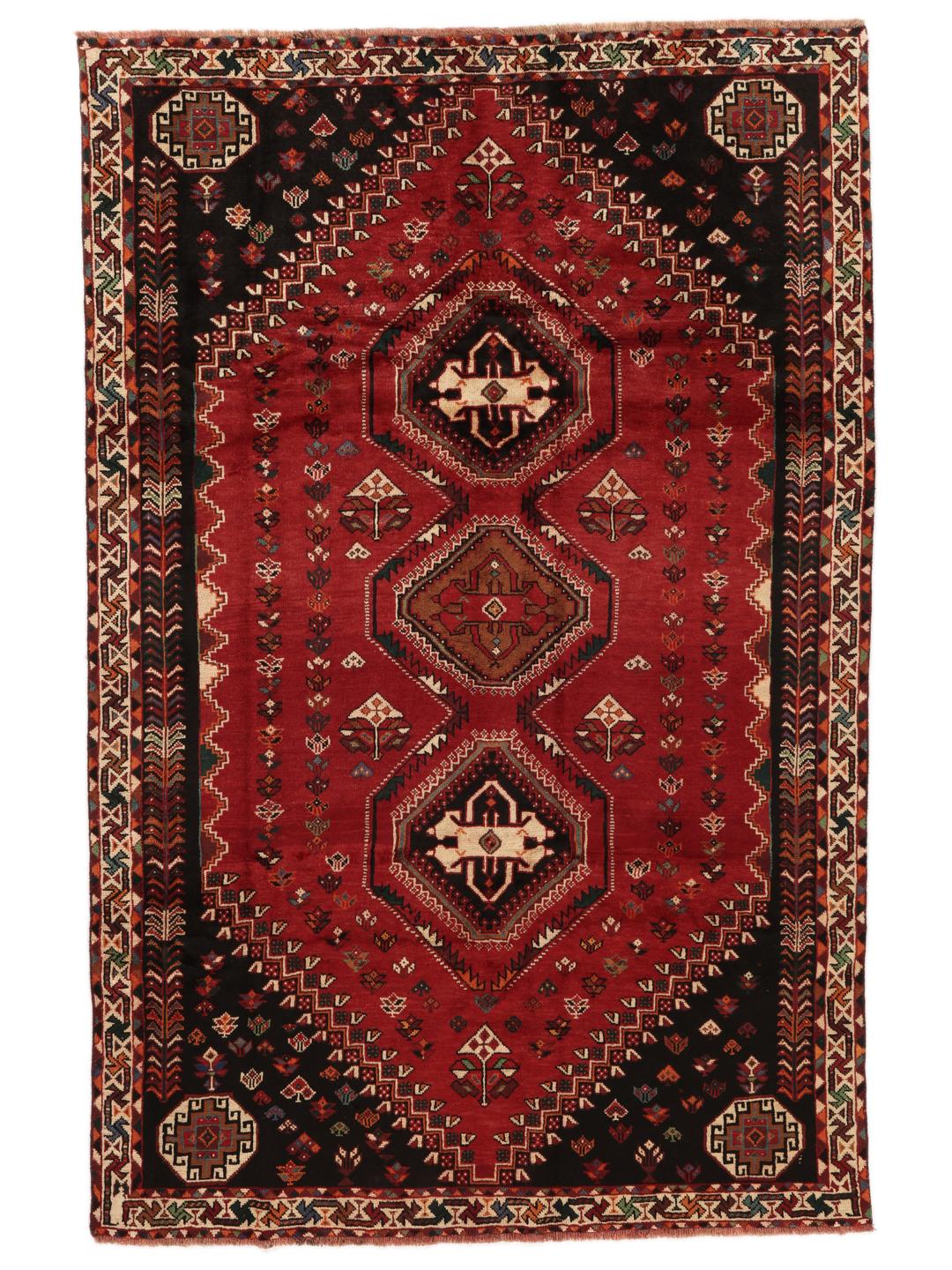 Hand-woven Shiraz rug from the Middle East featuring a vibrant red field and tribal motifs