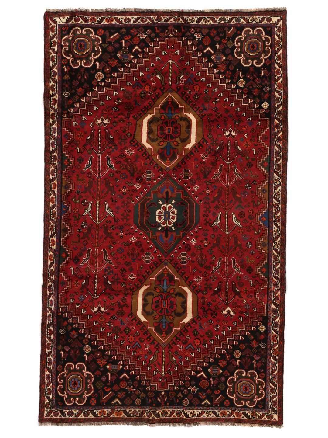 Hand-woven Shiraz rug from the Middle East featuring a red and black tribal pattern.