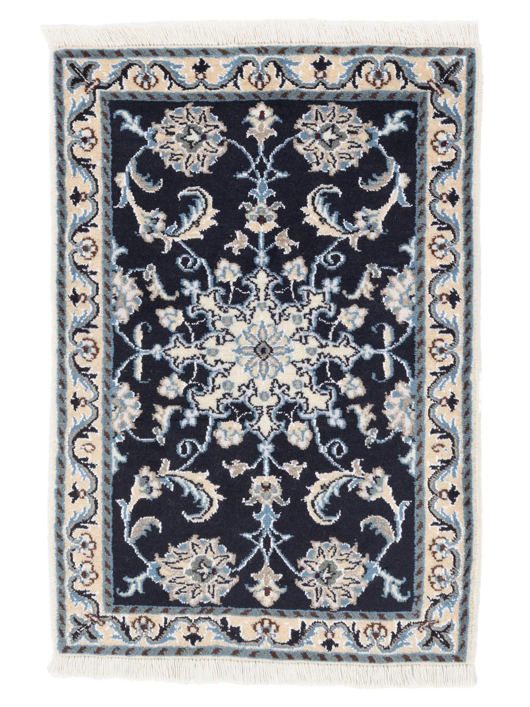 A hand-knotted Nain rug from the Middle East with a deep blue field and floral motifs.