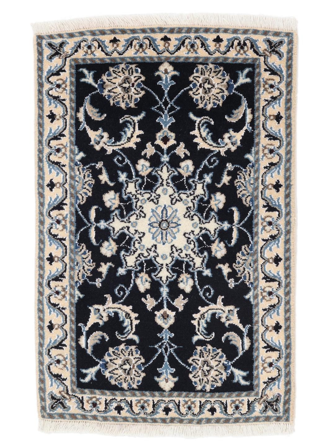 A hand-knotted Nain rug from the Middle East featuring a black field with floral patterns