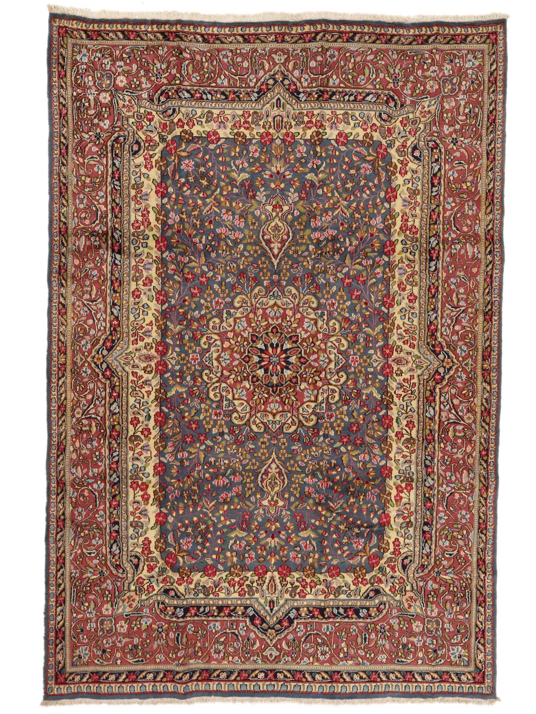 Handgeknoopt Kerman-tapijt met een blauw bloemenmedaillon en rode rand
