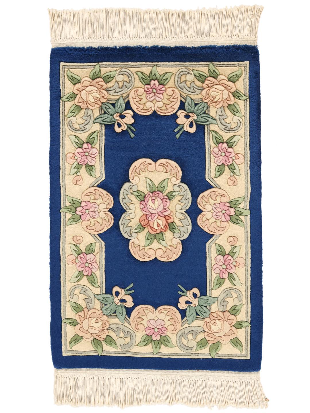 Hand-knotted floral rug from China with a deep blue background